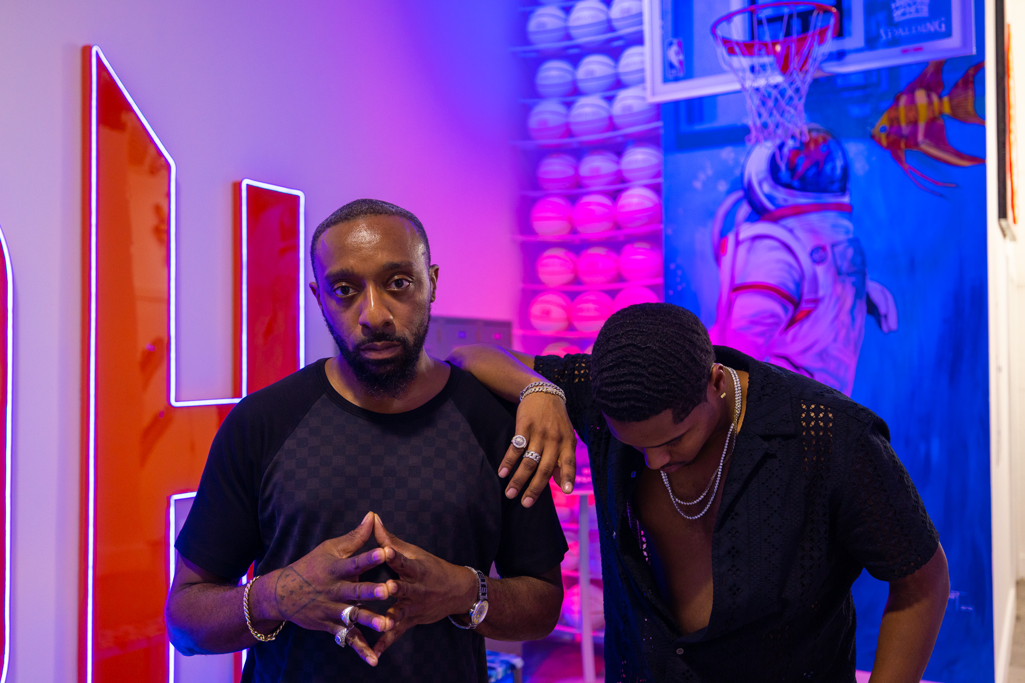 Original artist photograph supplied for the Frank AMIL and Dev AMIL feature, with two men against a vivid blue and purple backdrop.